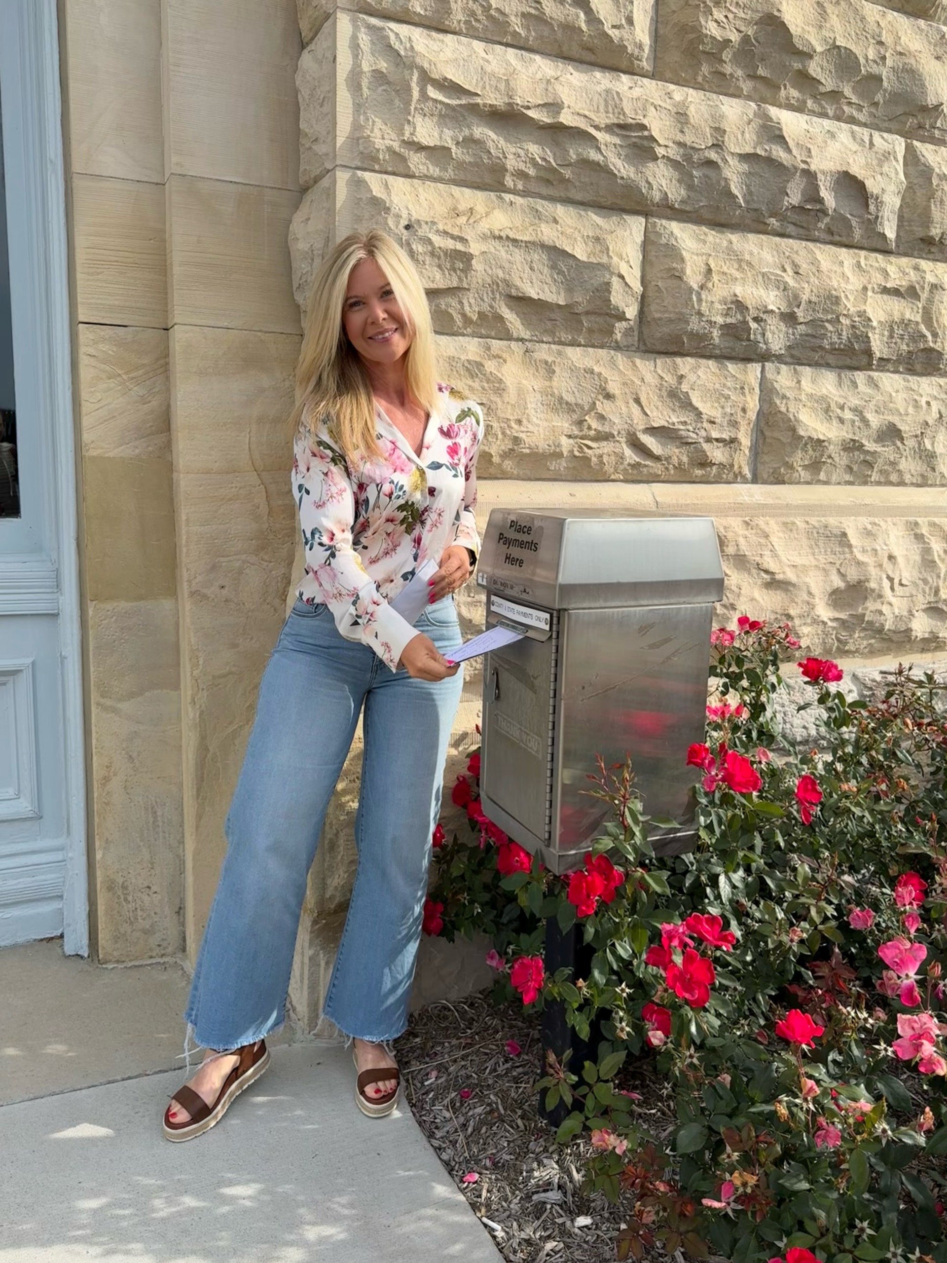 County Treasurer placing a payment in the courthouse dropbox.
